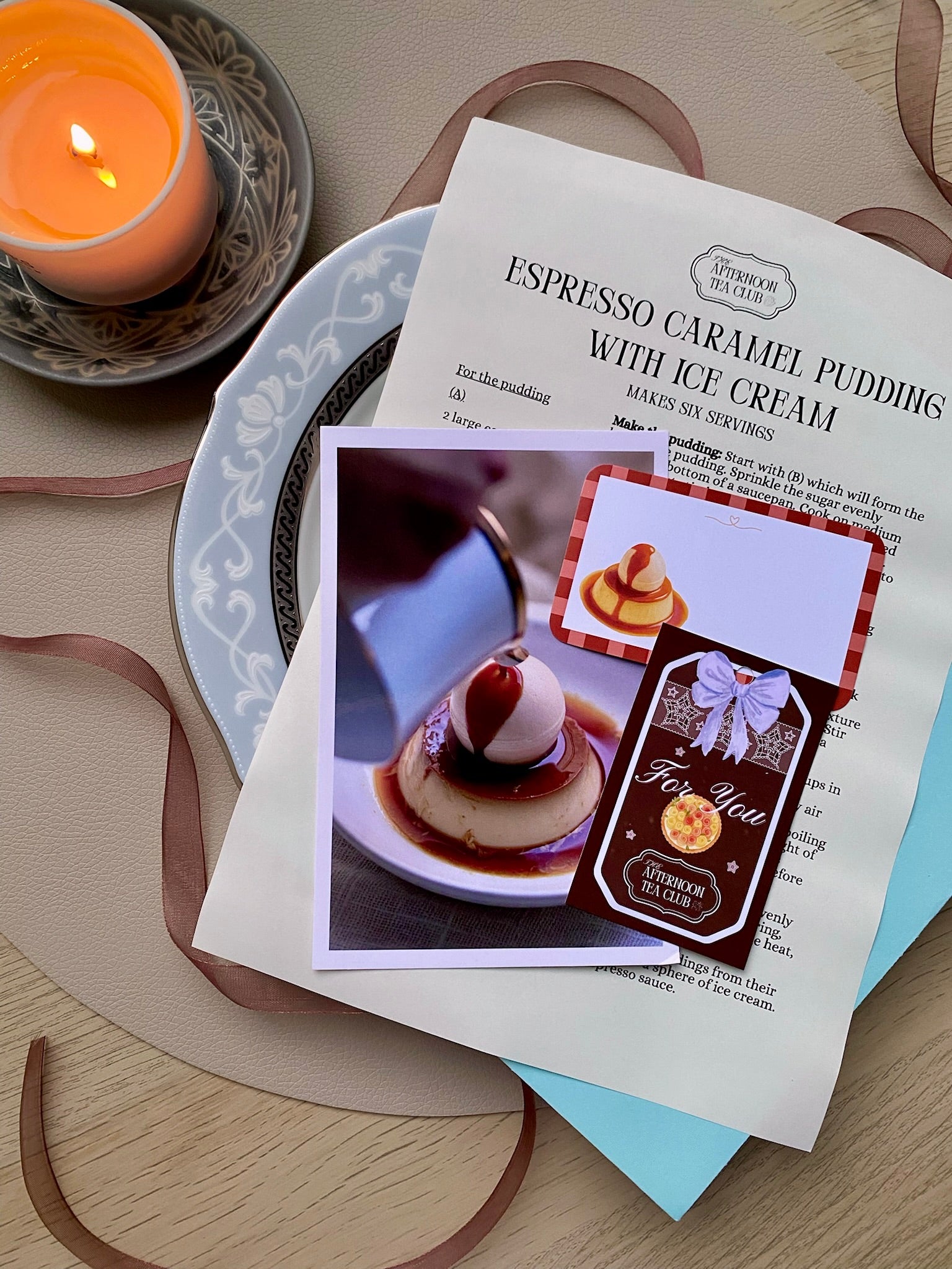 Espresso Caramel Pudding with Ice Cream recipe card on a wooden surface with a candle.