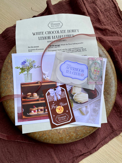 Collection of tea-themed cards and a paper on a wooden surface