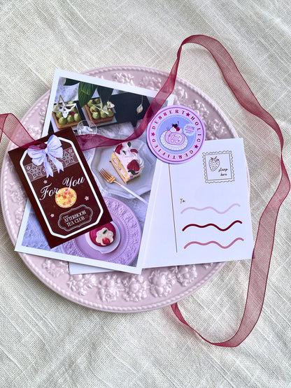 Stationery items including cards and a ribbon on a textured surface